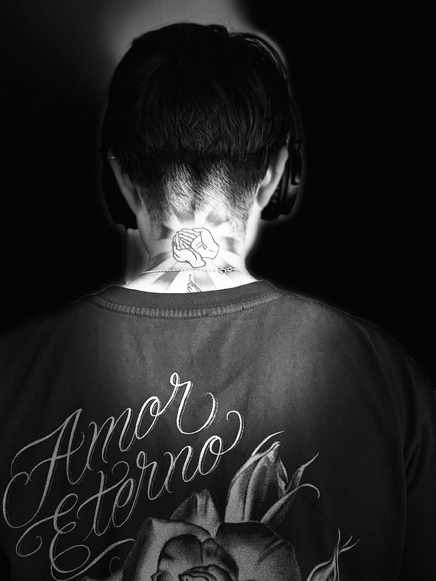DJ J Moon from behind wearing headphones